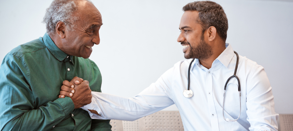 Doctor shaking hands with senior man